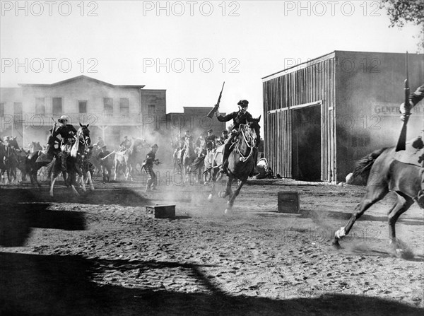 Bill Elliott (on horse, left), on-set of the western film, "Frontiers of '49", Columbia Pictures, 1939