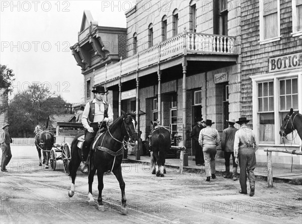 Rory Calhoun (on horse), on-set of the western film, "Domino Kid", Columbia Pictures, 1957