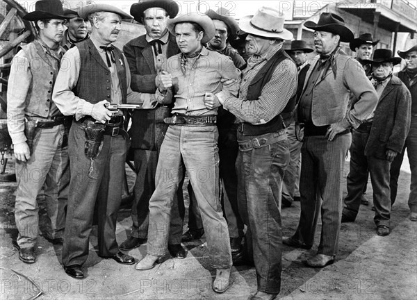 Audie Murphy (center), on-set of the western film, "Drums Across The River", Universal Pictures, 1954