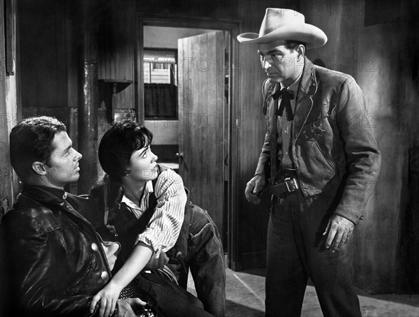 Audie Murphy (left), Susan Cabot, Stephen McNally (right), on-set of the western film, "The Duel At Silver Creek", Universal Pictures, 1952