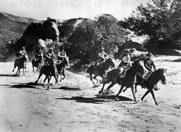 Gang of outlaws on horseback, on-set of the western film, "The Duel At Silver Creek", Universal Pictures, 1952