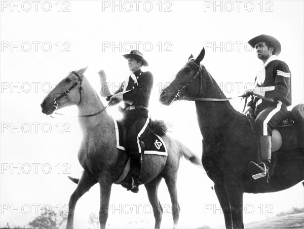 Bruce Bennett (left), on-set of the western film, "Flaming Frontier", 20th Century-Fox, 1958