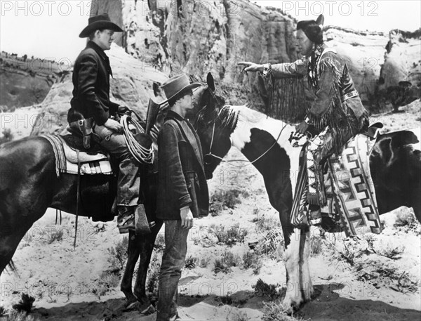 Ben Johnson (on horse), Peter Graves (standing center),  on-set of the western film, "Fort Defiance", United Artists, 1951