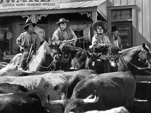 Andy Devine (2nd left), Leo Carrillo (2nd right), on-set of the western film, "Frontier Badmen", Universal Pictures, 1943