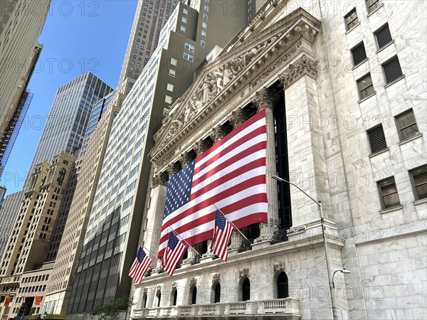 New York Stock Exchange, building exterior draped with large American flag, New York City, New York, USA