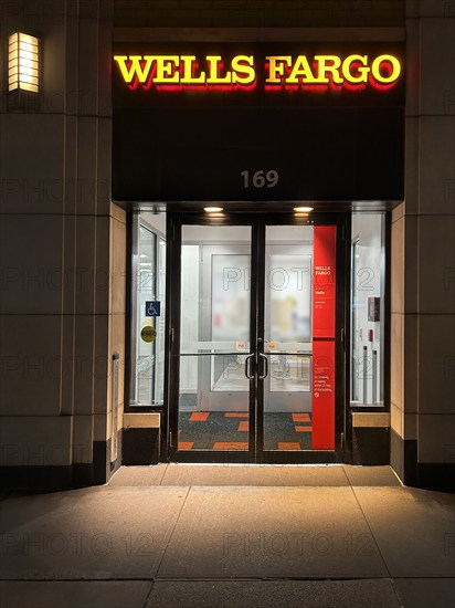 Wells Fargo Bank, building exterior and entrance at night, New York City, New York, USA