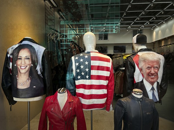 Clothing store window featuring images of Kamala Harris and Donald Trump on the backs of jackets, New York City, New York, USA