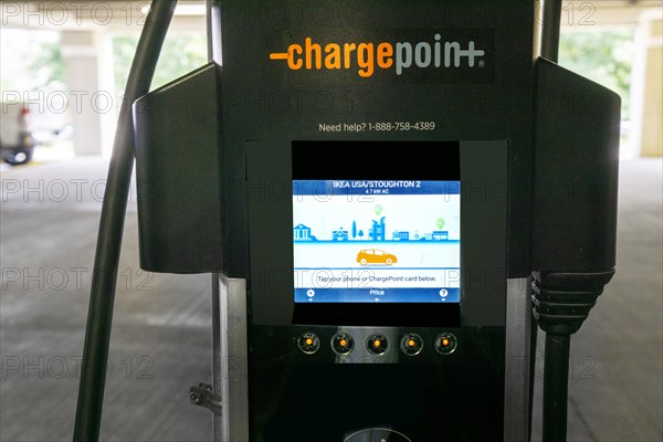 Close-up of electric vehicle charging station touch screen, IKEA home furnishings store parking lot, Stoughton, Massachusetts, USA