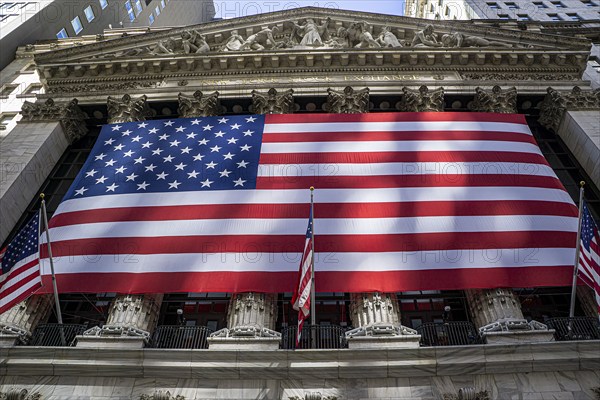 New York Stock Exchange, building exterior draped with large American flag, New York City, New York, USA