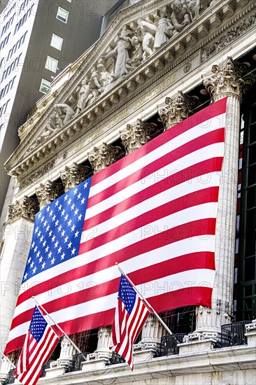 New York Stock Exchange, building exterior draped with large American flag, New York City, New York, USA