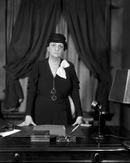 Frances Perkins, U.S. Secretary of Labor 1933-45, half-length portrait standing at her desk, Washington, D.C., USA, Harris & Ewing, 1934