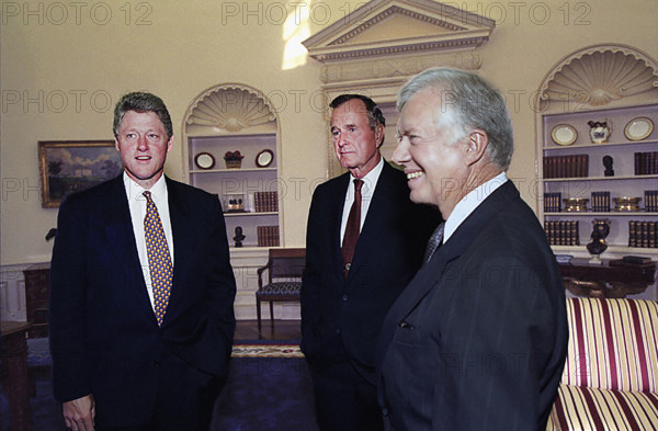 U.S. President Bill Clinton talking with former U.S. Presidents George H.W. Bush and Jimmy Carter, Oval Office, White House, Washington D.C., USA, Bob McNeely, White House Photograph Office, September 13, 1993