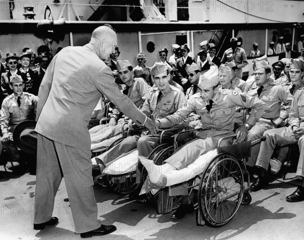 U.S. President Dwight D. Eisenhower greeting hospitalized veterans at Washington Navy Yard who were the last group to take cruise on Presidential Yacht, USS Williamsburg, Washington, D.C., USA, Abbie Rowe, White House Photographs, June 25, 1953