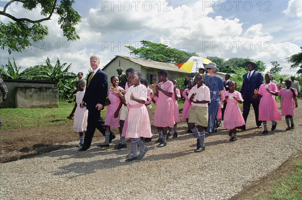 U.S. President Bill Clinton and U.S. First Lady Hillary Rodham Clinton walk with school children, Kisowera School, Mukono, Uganda, Barbara Kinney, White House Photograph Office, March 24, 1998