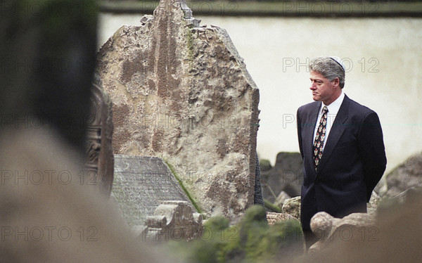 U.S. President Bill Clinton walking among graves during visit to historic Jewish cemetery, Prague, Czech Republic, Barbara Kinney, White House Photograph Office, January 12, 1994