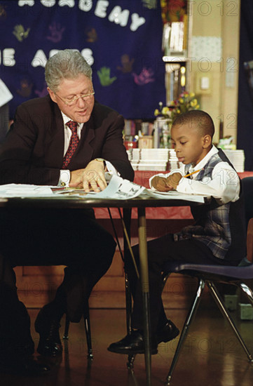 U.S. President Bill Clinton attending tutoring session with young boy, Jenner Elementary School, Chicago, Illinois, USA, Barbara Kinney, White House Photograph Office, September 25, 1998