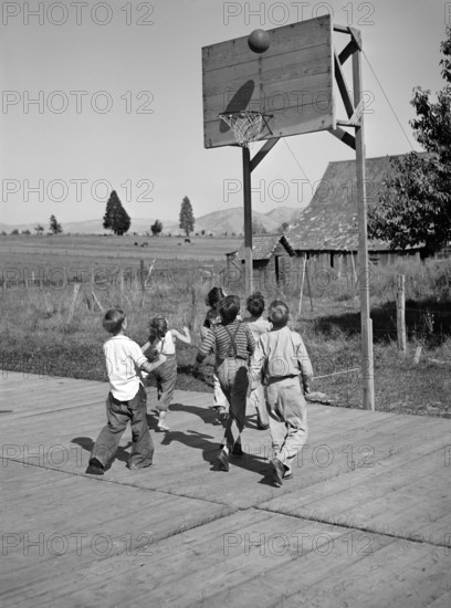 Group of children playing basketball at Farm Security Administration (FSA) mobile camp for migratory farm workers, Odell, Oregon, USA, Russell Lee, U.S. Farm Security Administration, September 1941