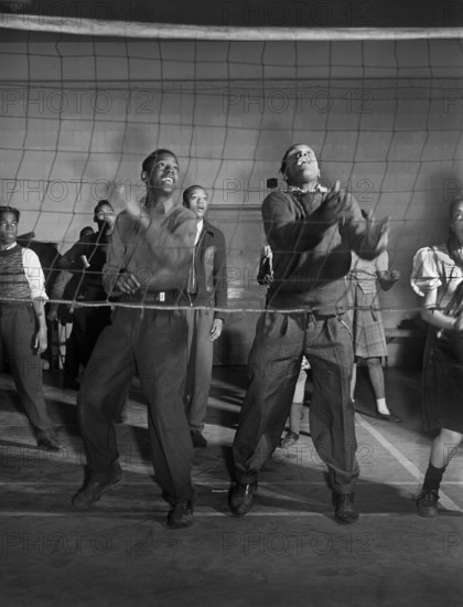 Young "Wellstowners" playing volleyball in recreation hall at community center, Ida B. Wells Housing Project, Chicago, Illinois, USA, Jack Delano, U.S. Farm Security Administration, March 1942