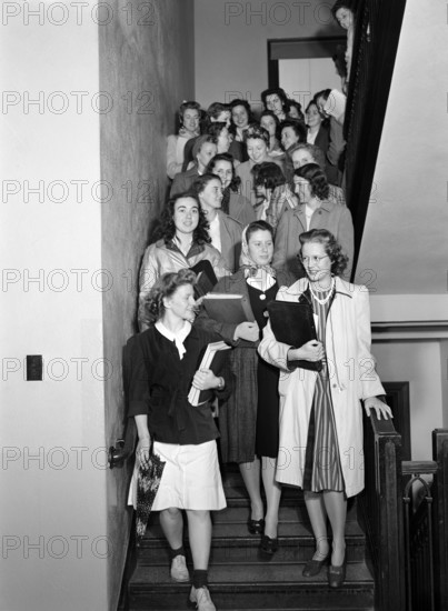 Group of young adult women in stairwell between classes in Home Economics building, Iowa State University, Ames, Iowa, USA, Jack Delano, U.S. Farm Security Administration, May 1942