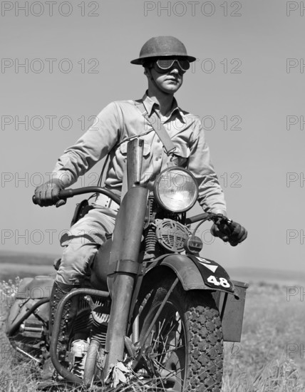 Motorcyclist serving as messenger for his platoon of the mechanized cavalry reconnaissance unit, Fort Riley, Kansas, USA, Jack Delano, U.S. Office of War Information, April 1942