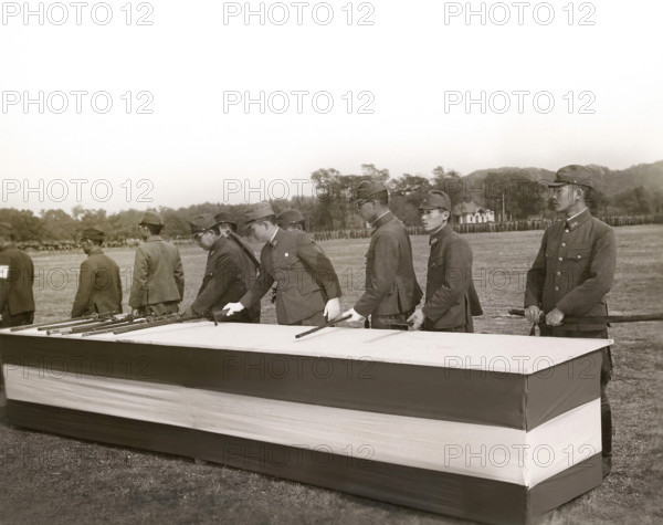 Japanese surrender party placing swords on table in final act of surrender in the presence (not shown) of Major General Lemuel C. Shepherd Jr., Commanding Officer of the Sixth Marine Division, and General Shen Pao Cheng, representing Chinese government, Qingdao, Shandong, China, Connolly, U.S. Marine Corps, October 25, 1945