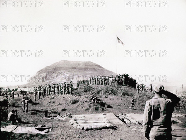 U.S. Marines of Fifth Marine Division raise American flag up flagpole after battle was won, Mount Suribachi, Iwo Jima, Dodd, U.S. Marine Corps, March 14, 1945