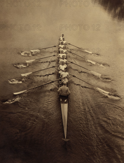 Eight rowers and coxswain rowing in sculling boat on river, Cambridge, England, UK, Bain News Service, 1910's