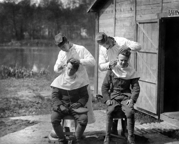 U.S. soldiers getting hair cut, 166th Field Hospital, Baccarat, France, U.S. Army Signal Corps, May 15, 1918