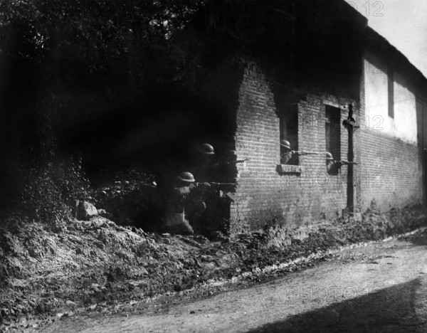 Sharpshooters with good view of enemy from shelter behind old brick wall, 28th Infantry, Bonvillers, France, U.S. Army Signal Corps