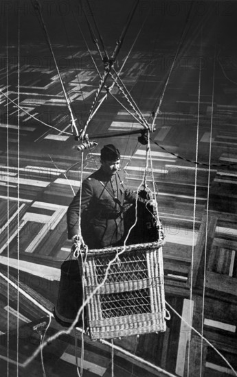 Close-up view of American major in observation balloon basket flying over territory near front lines, France, U.S. Army Signal Corps, June 1918