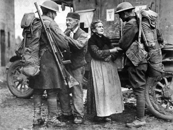 French couple, M. and Mme. Baloux, under German occupation for over four years, greeting U.S. soldiers of the 308th and 166th Infantries upon their arrival during the American advance, Brieulles-sur-Bar, France, U.S. Army Signal Corps, November 6, 1918