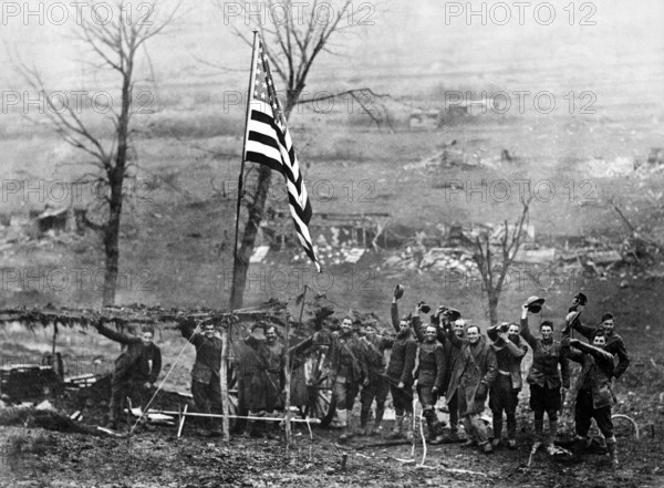 Gun from Battery D, 105th Field Artillery, showing American flag, hoisted after last shot was fired when the armistice took effect, Etraye, France, U.S. Army Signal Corps, November 11, 1918