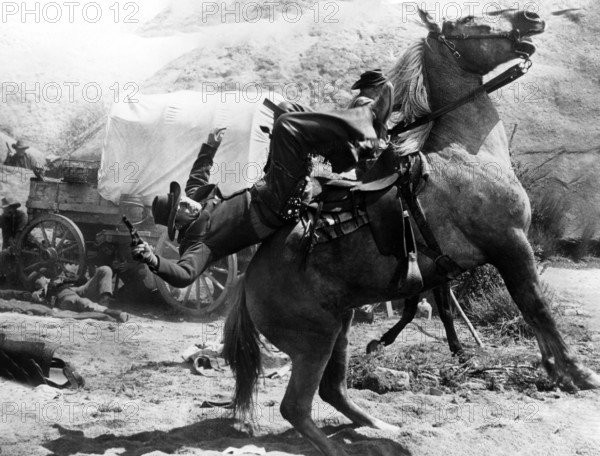 Cattle rustler being shot on horseback, on-set of the western film, "Gun For A Coward", Universal Pictures, 1957