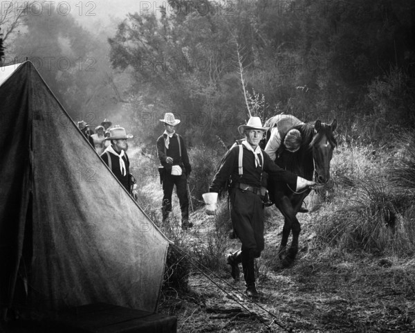 Roy Gordon (walking with horse), Richard Denning (injured on horse), on-set of the western film, "The Gun That Won The West", Columbia Pictures, 1955