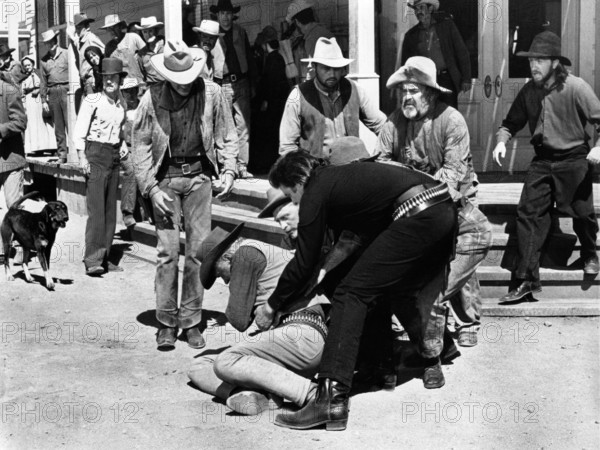 Robert J. Wilke (on ground), Johnny Cash (lifting Wilkie), Kirk Douglas (head partially obscured), on-set of the western film, "A Gunfight", Paramount Pictures, 1971