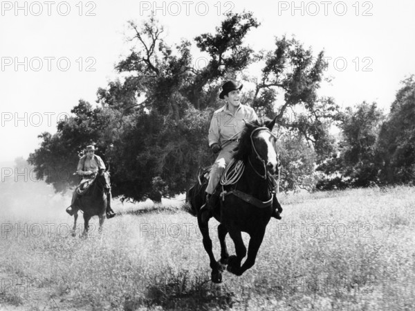 Bobby Darin (foreground), Don Galloway (background), on-set of the western film, "Gunfight In Abilene", Universal Pictures, 1957