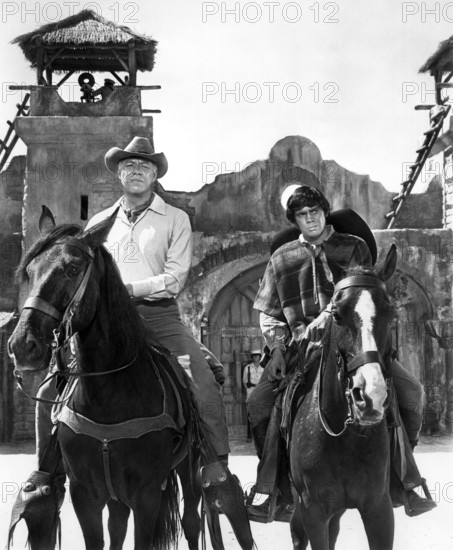 George Kennedy, Reni Santoni, on-set of the western film, "Guns Of The Magnificent Seven", United Artists, 1969