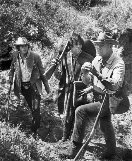 Joe Don Baker, Reni Santoni, George Kennedy, on-set of the western film, "Guns Of The Magnificent Seven", United Artists, 1969