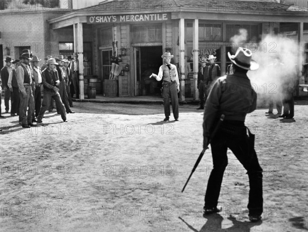 Paul Kelly (gun duel front view), Audie Murphy (gun duel rear view) , on-set of the western film, "Gunsmoke", Universal Pictures, 1953