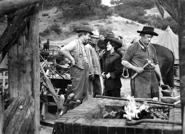 Jesse White (left), Susan Cabot, on-set of the western film, "Gunsmoke", Universal Pictures, 1953