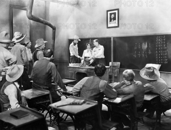 Lina Basquette (at desk, center), Hoot Gibson (at desk, right), on-set of the western film, "The Hard Hombre", Allied Pictures, 1931