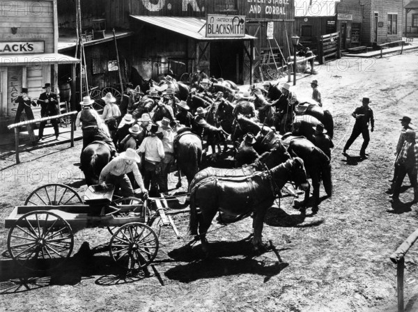 Harry Carey, Walter Huston (with rifles fending off mob), on-set of the western film, "Law And Order", Universal Pictures, 1932