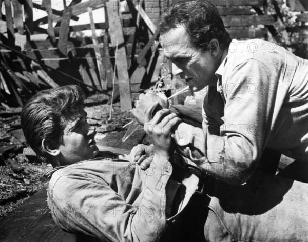 Michael Landon (left), Jack Hogan, on-set of the western film, "The Legend Of Tom Dooley", Columbia Pictures, 1959