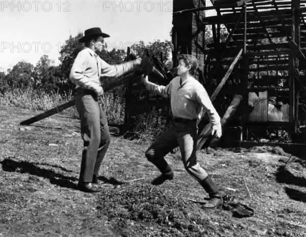 Michael Landon (right), Jack Hogan (left), on-set of the western film, "The Legend Of Tom Dooley", Columbia Pictures, 1959