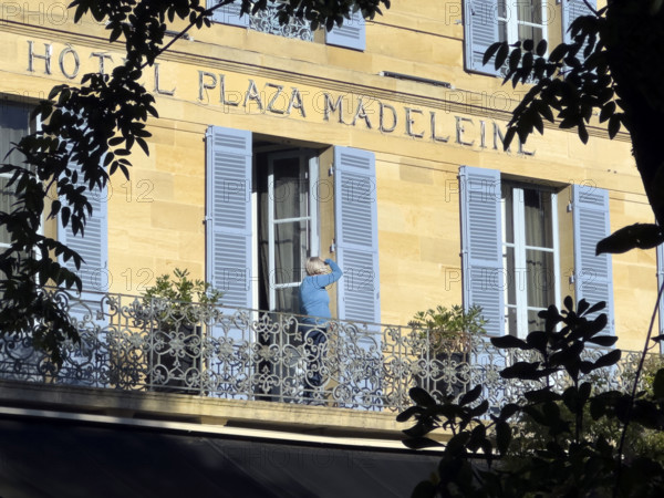 Hotel Plaza Madeleine, building exterior with woman standing on balcony, Sarlat-la-Canéda, Dordogne, France