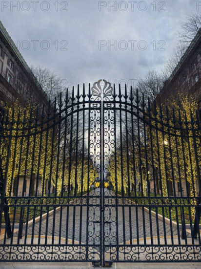 Entrance Gate at College Walk at dusk with illuminated lights wrapped around trees, Columbia University, New York City, New York, USA