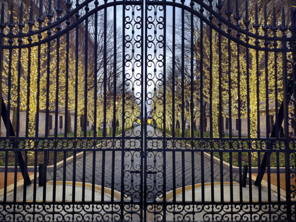 Entrance Gate at College Walk at dusk with illuminated lights wrapped around trees, Columbia University, New York City, New York, USA