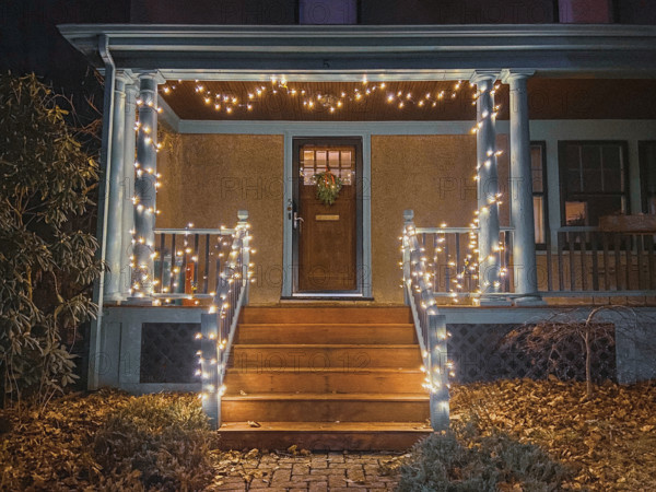 White LED Christmas lights decorating front porch of house