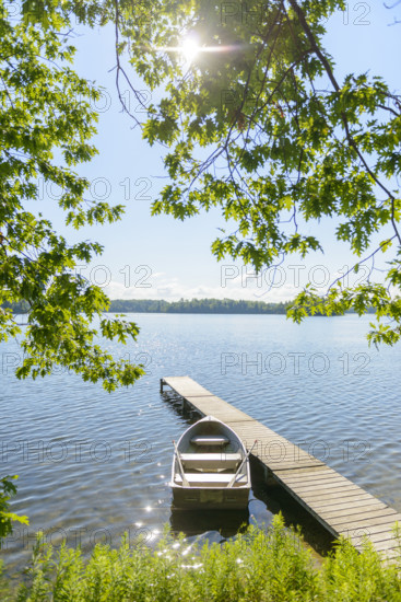 Row boat moored at dock on scenic lake