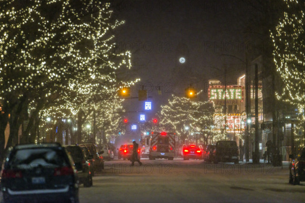 Snowy street scene at night, Traverse City, Michigan, USA